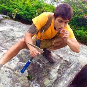 Avrahami doing mineral taste test during geology fieldwork